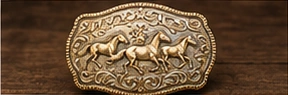 Equestrian buckle design study with horses in relief.
